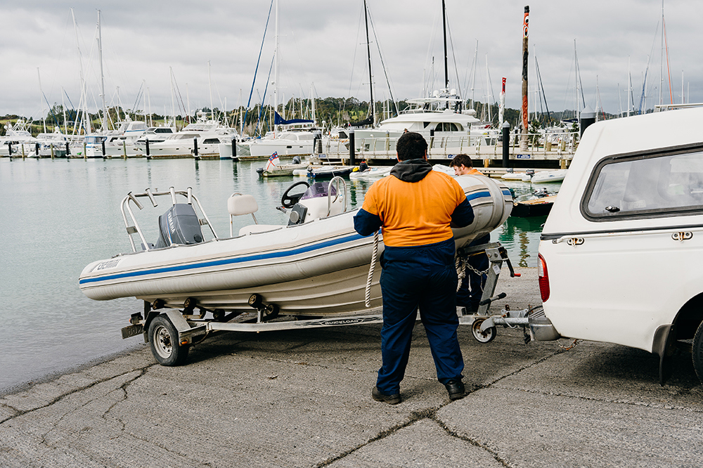 Two men launching a boat.