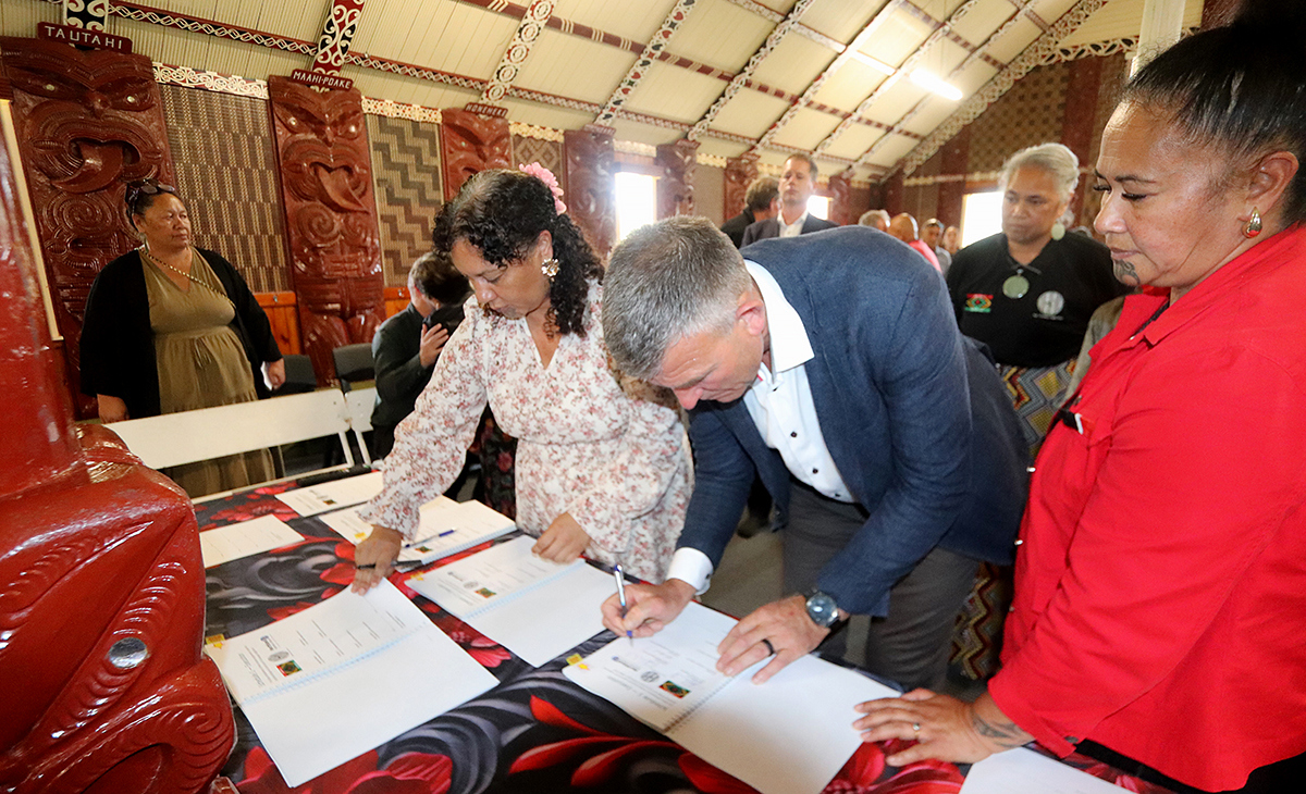 People signing documents.